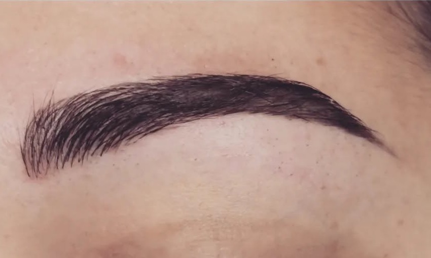 Sourcil foncé redessiné en combinaison : traits poil à poil et effet poudré